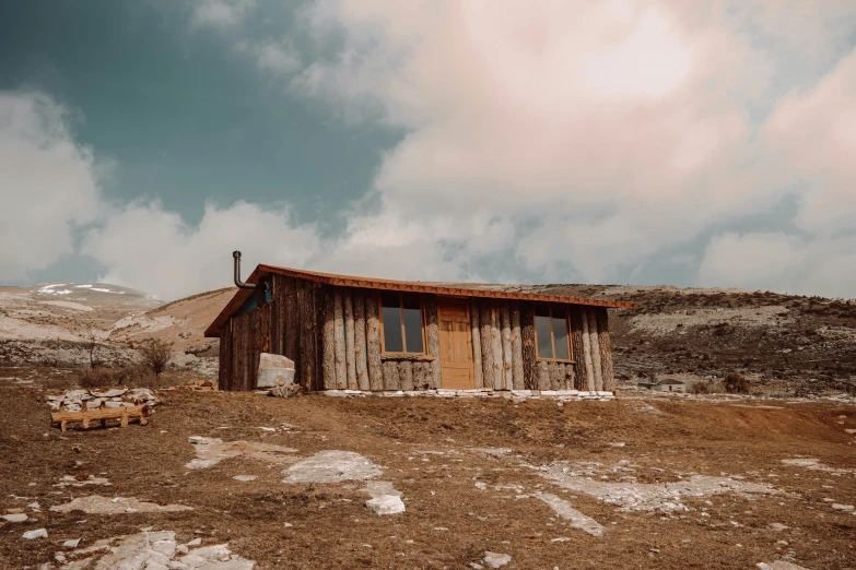 a large building sits on a rocky outcropping