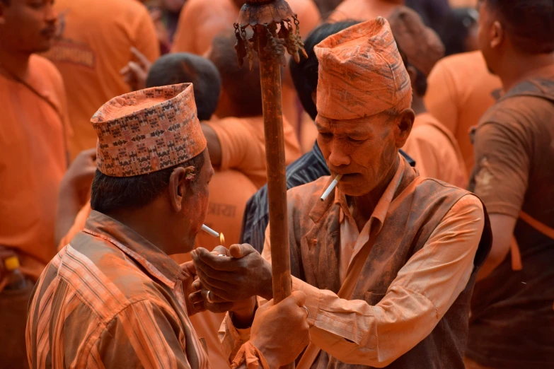 two men are standing together holding a stick