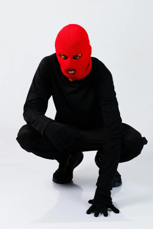 an evil man in black pants and a red mask