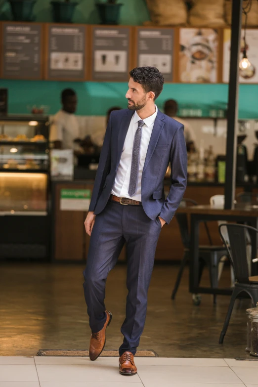 a man in a suit and tie stands on the floor