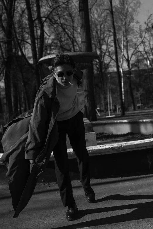 a woman walks on the sidewalk with her umbrella open