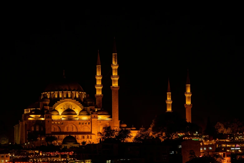 large ornate building lit up at night with lights in the sky