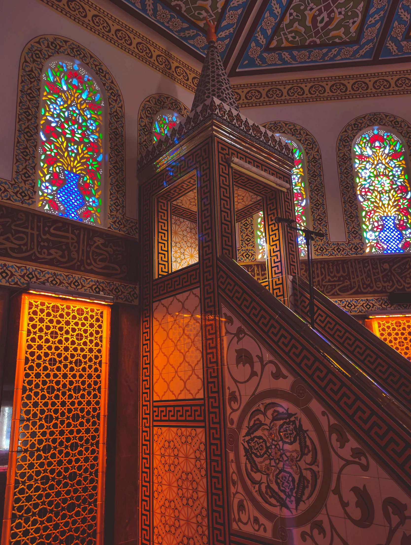 the stairs and stained glass windows of a building