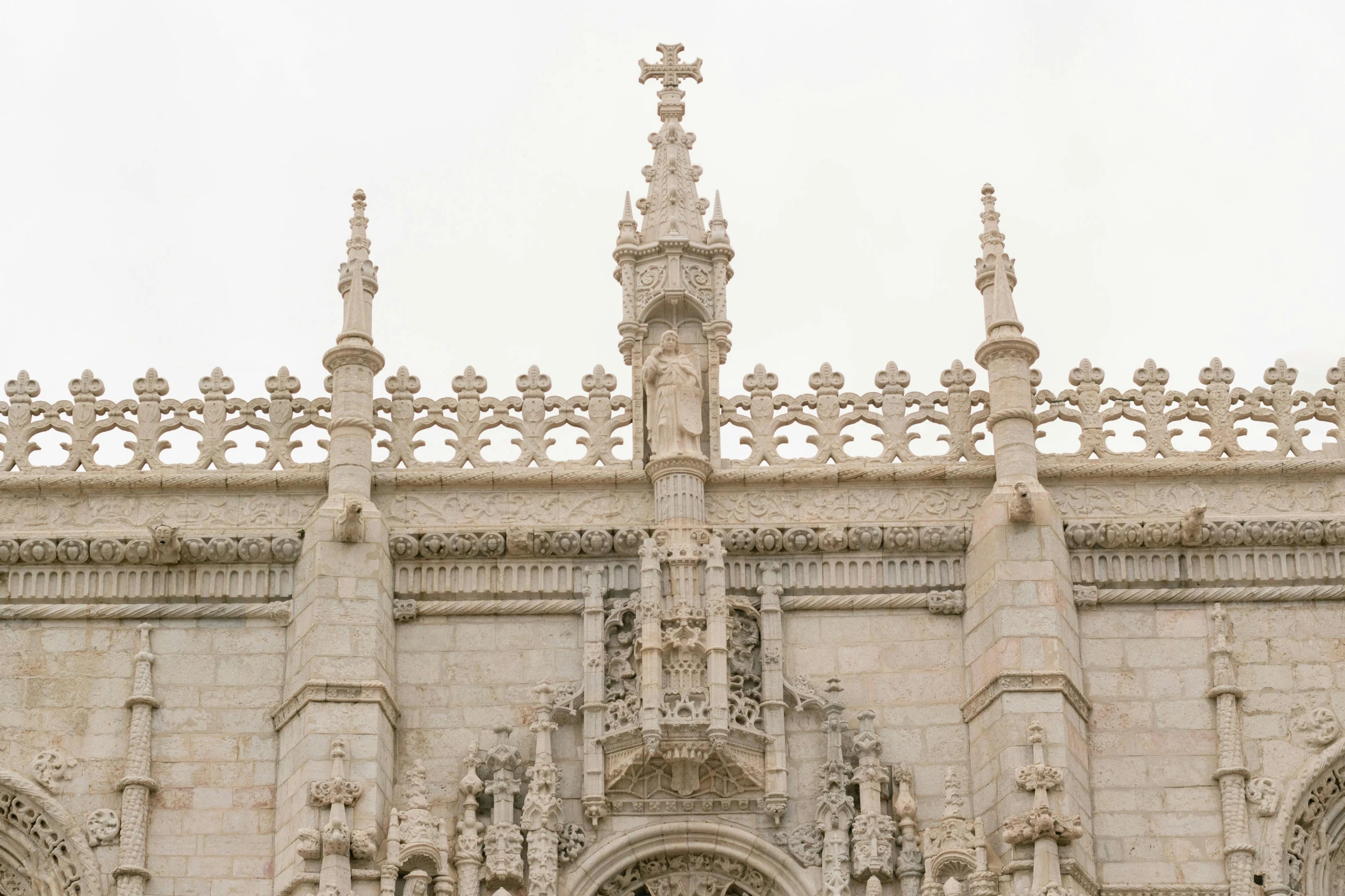 a gothic building with clocks and pillars on it's side