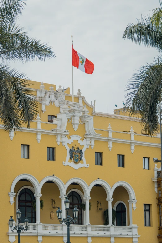 an orange and yellow building with a red flag