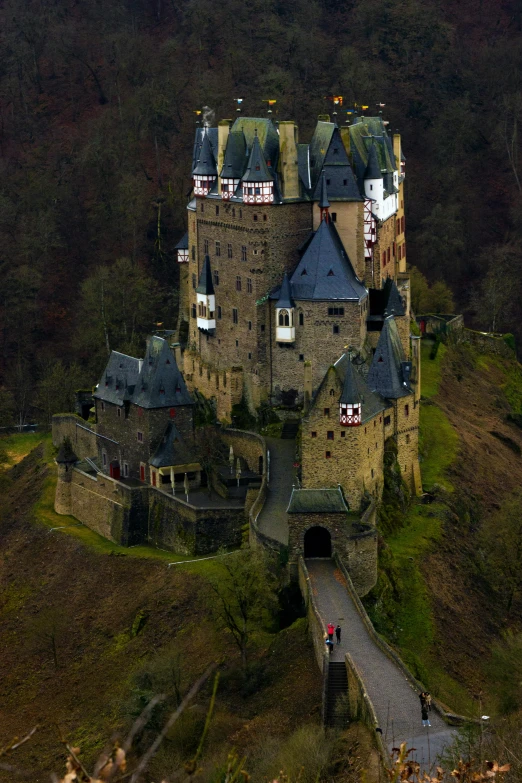 a castle in a hilly area of mountains