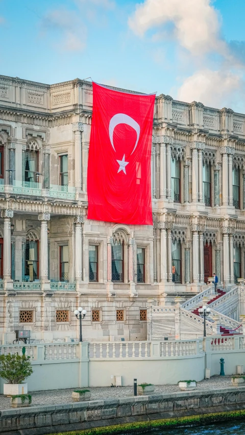 a flag flying from the top of a large building