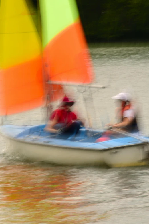 a group of people riding a blue boat on water