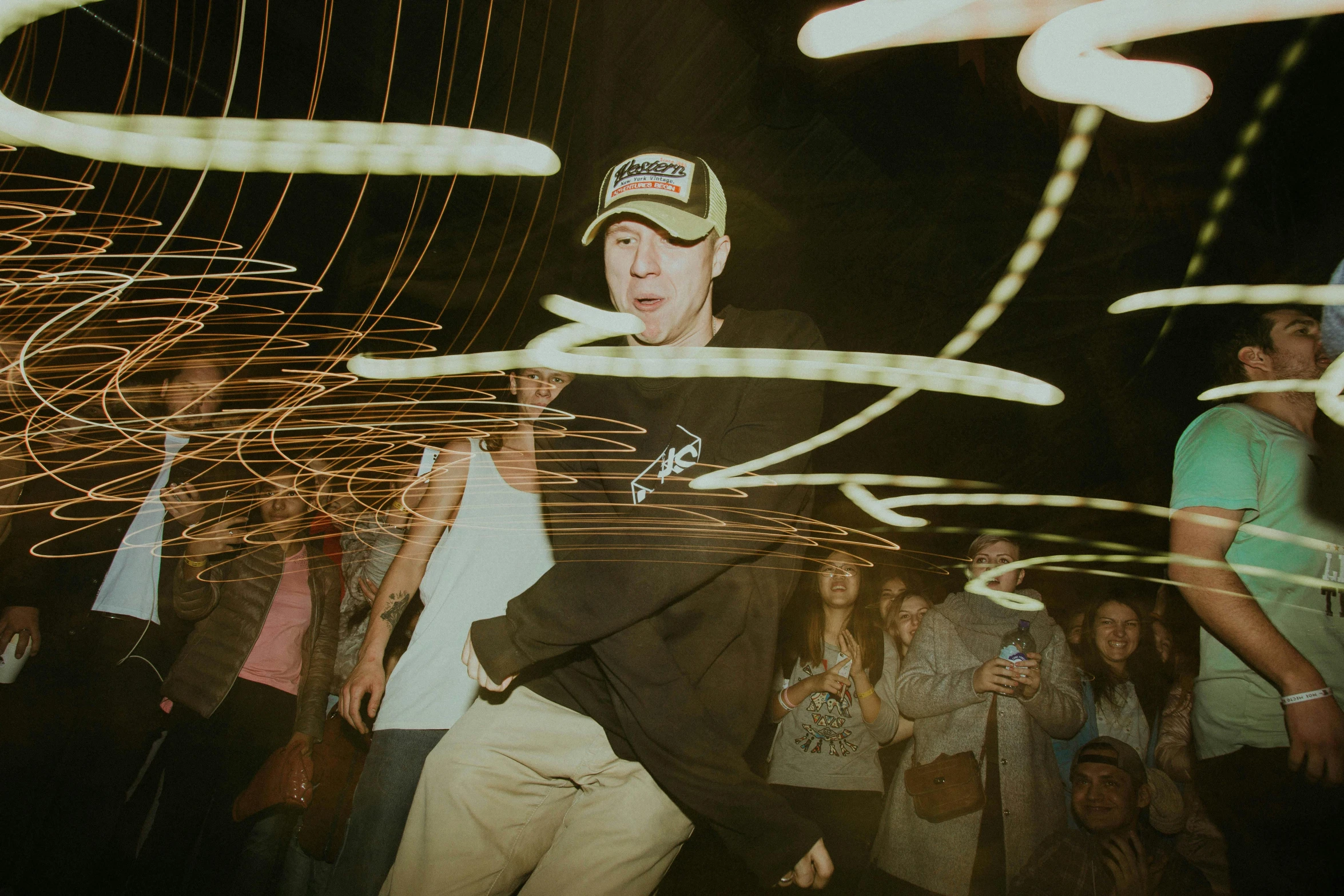 a young man with a green cap dancing