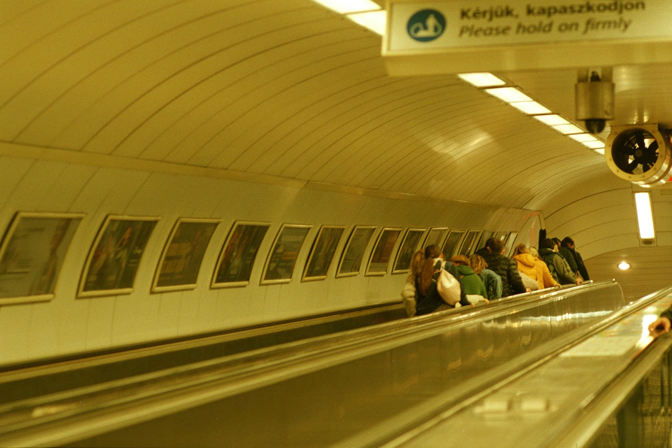 several people are moving on an underground train