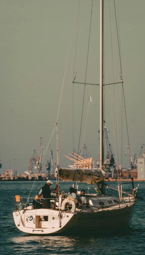 sailboat with sails and masts floating in the water