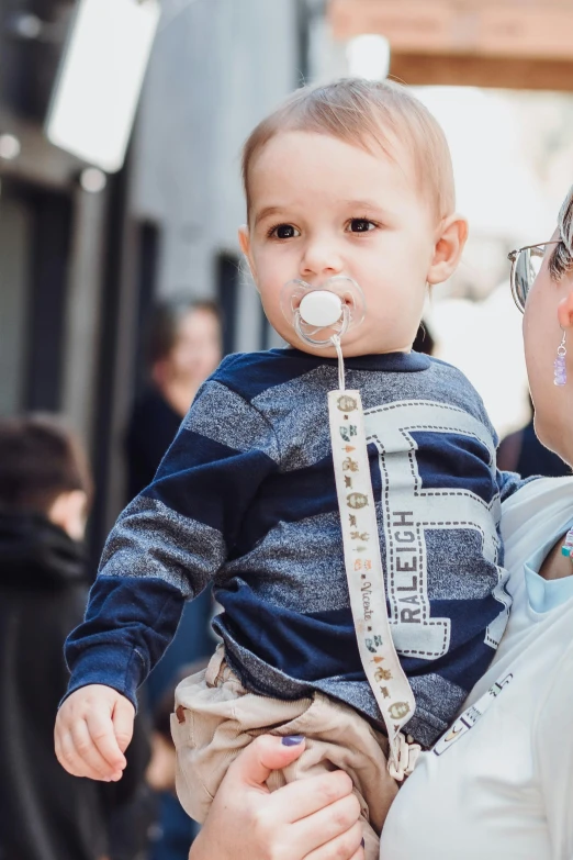 a woman holding a small baby in her lap