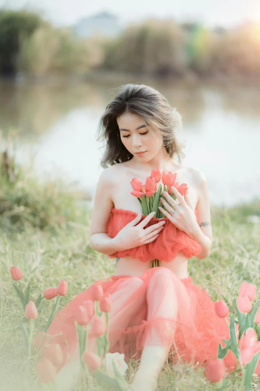 a young lady with tulips poses in an image