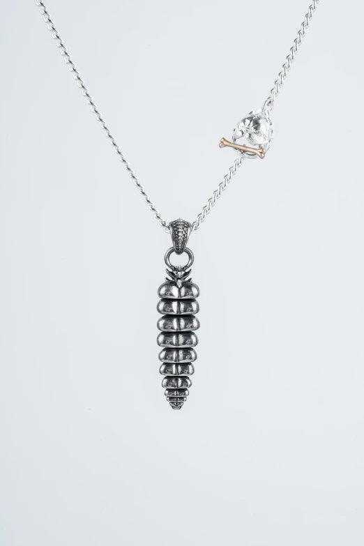 silver jewelry with a pendant of a piece of metal on a chain