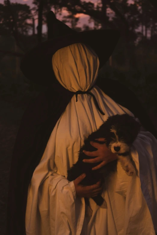 a woman is dressed as an nun holding a dog