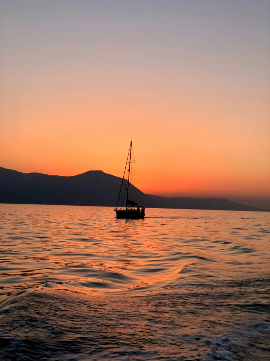 the lone boat is out on the water at sunset