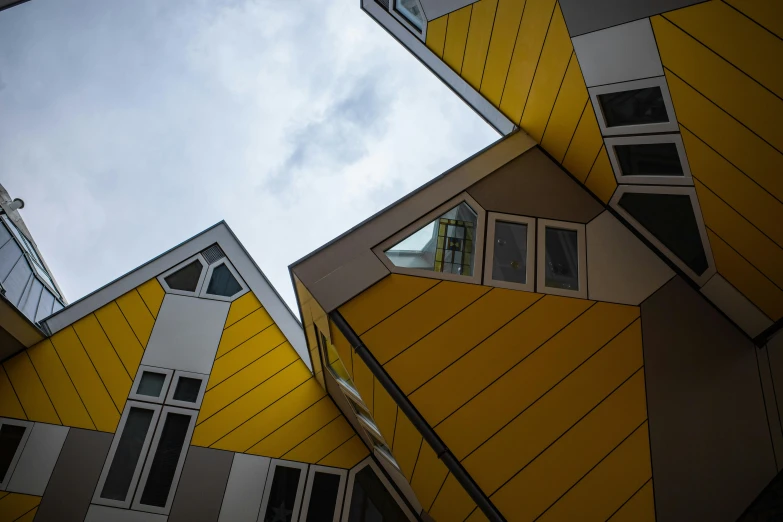 yellow and grey buildings with sky in the background