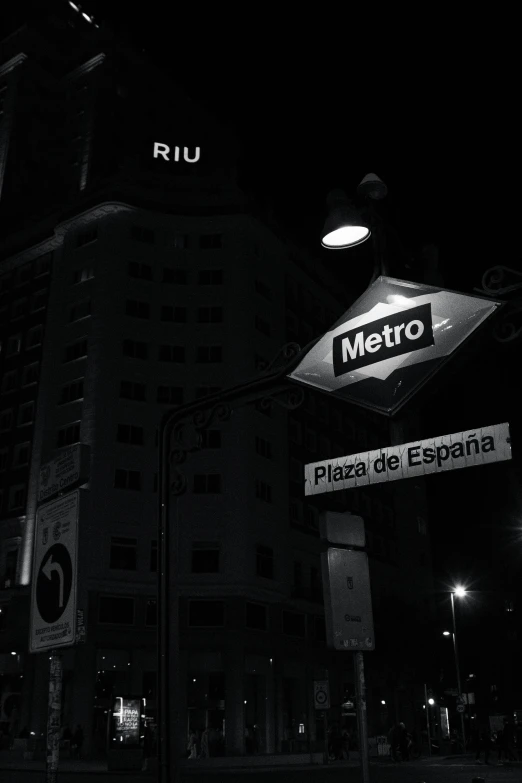 a sign reads metro is lit in black and white