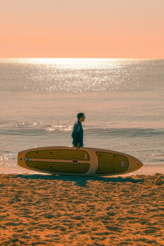 a person is on the beach with a surf board