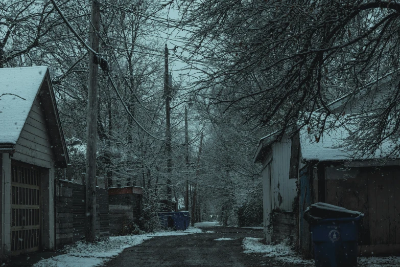 a narrow street with snow on the ground