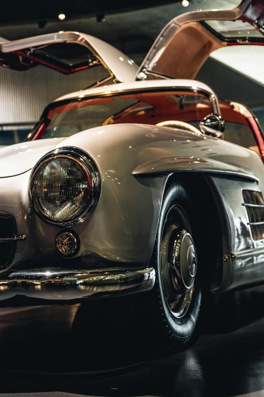 an old mercedes sports car is on display
