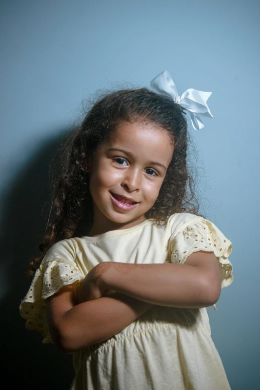 a  poses for a portrait on a blue background