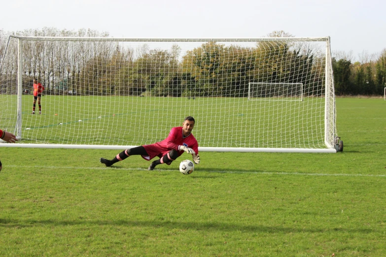 two men are chasing after a soccer ball in a field