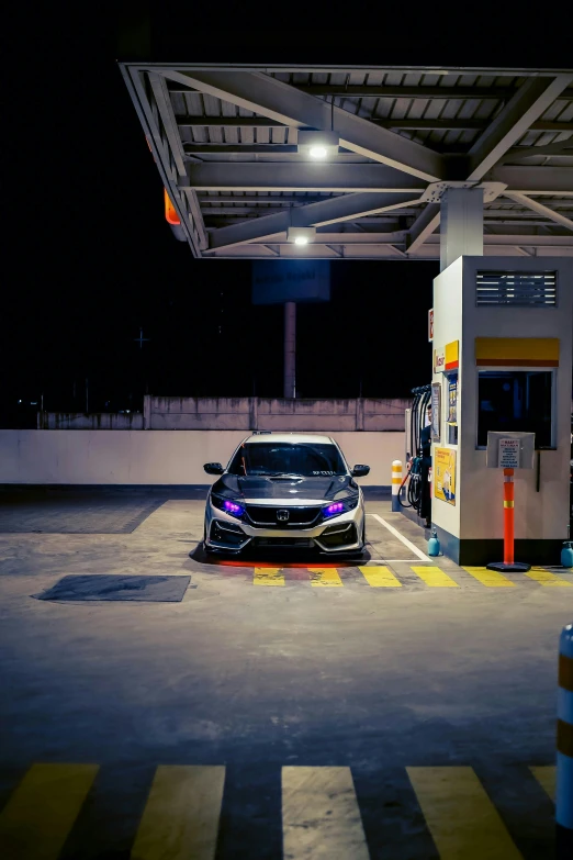 a mercedes parked in front of a gas station