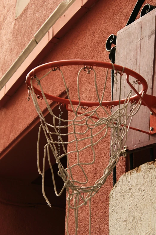 a basketball net attached to a red building