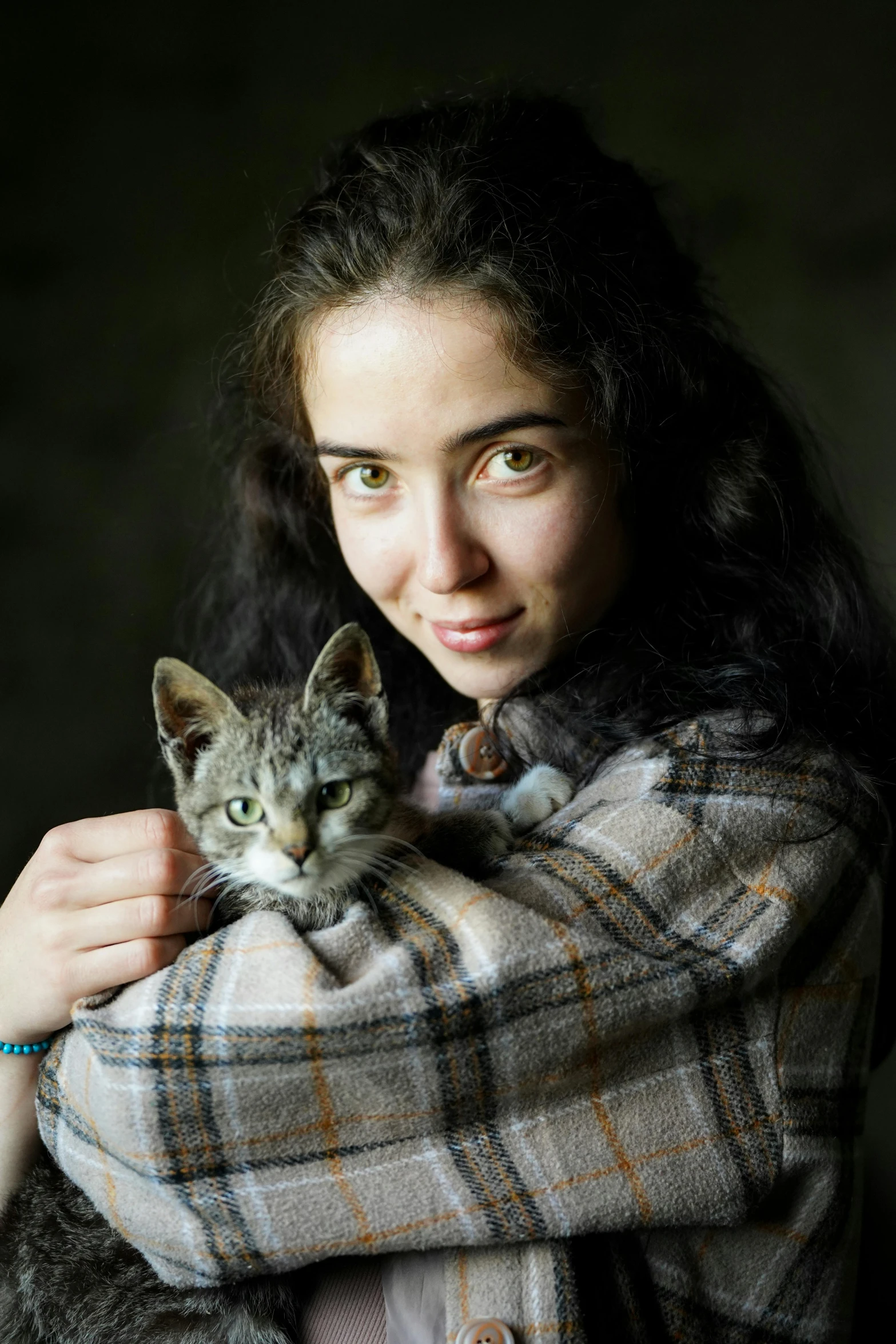 a woman holds her cat on her back