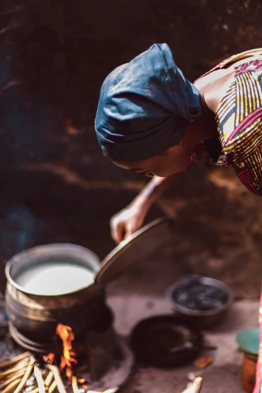 an image of a man stirring soing in a bowl