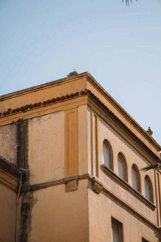 the clock is mounted to the side of the building