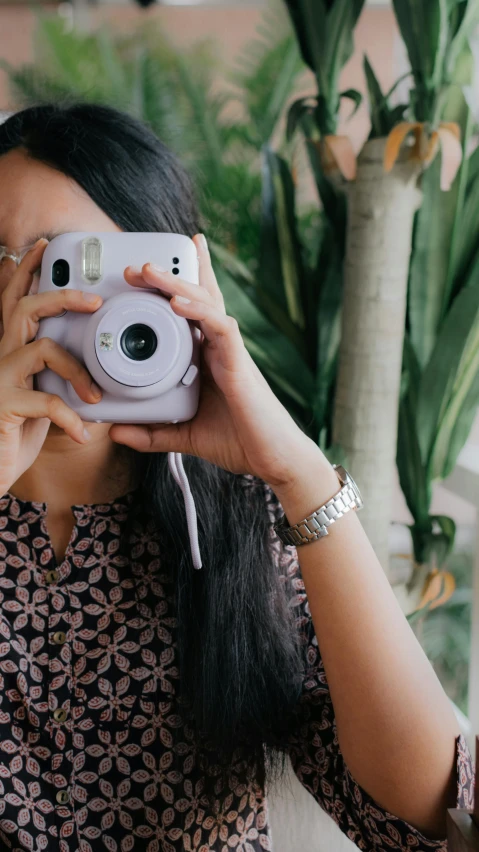 a woman taking a pograph with her digital camera