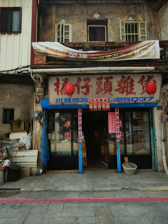 an asian street with stores and chairs on the front