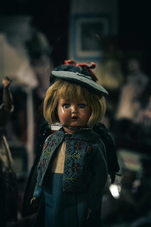 a doll is wearing a blue shirt and a hat