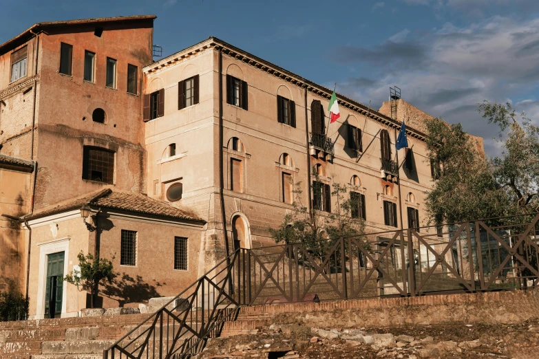 an old building on the corner of a street with stairs to the other side