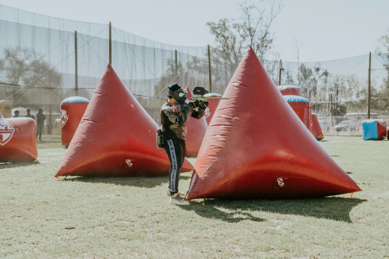 a woman is standing in front of some cones