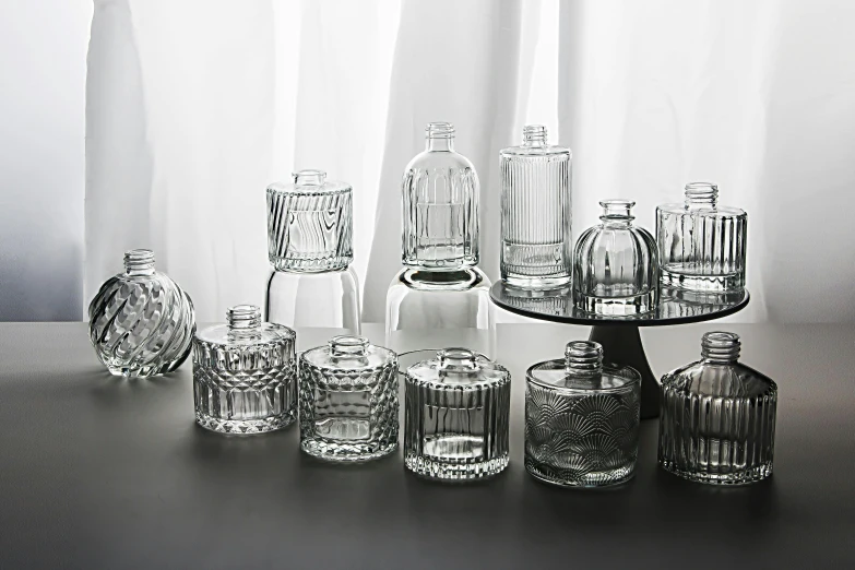 several clear vases sitting next to each other on a table