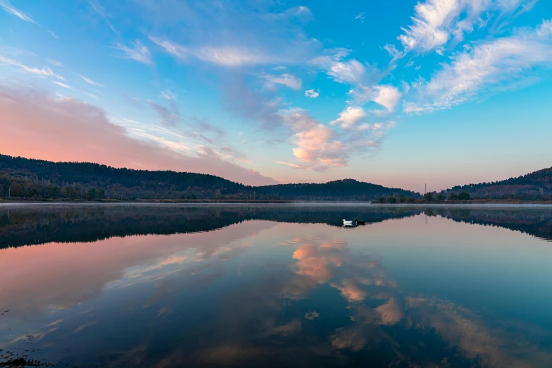 a beautiful scene at sunset over the lake