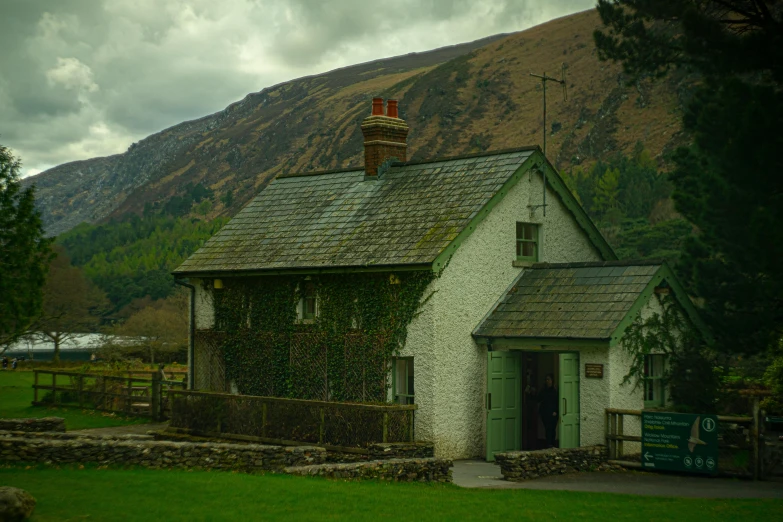 a small stone house with two windows in the middle of it