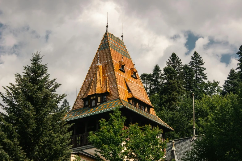 the tower of a building with wooden shingled and roof top