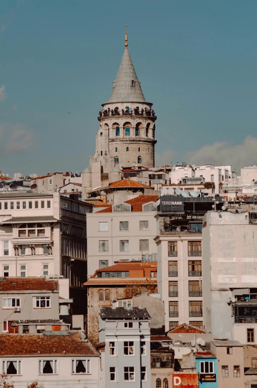 the tower of the city building stands out against the backdrop of some buildings