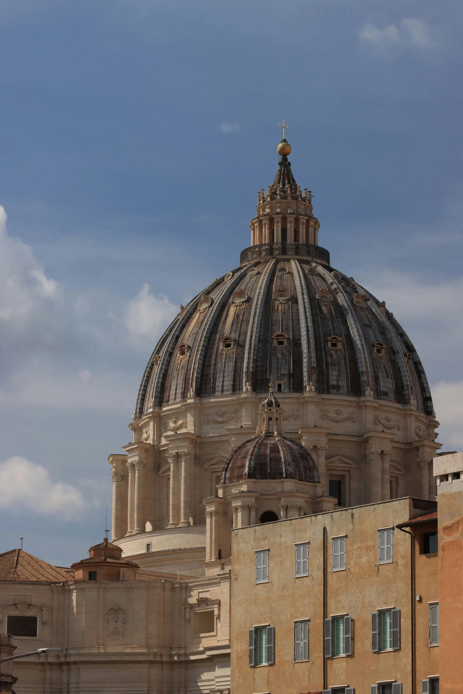 a dome structure against the backdrop of buildings in the city