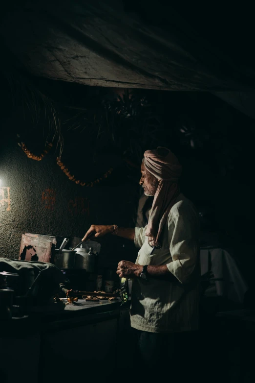 a woman standing in a kitchen cooking food