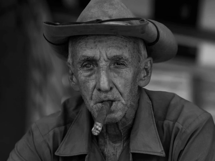 an old man with a hat and cigarette in his mouth