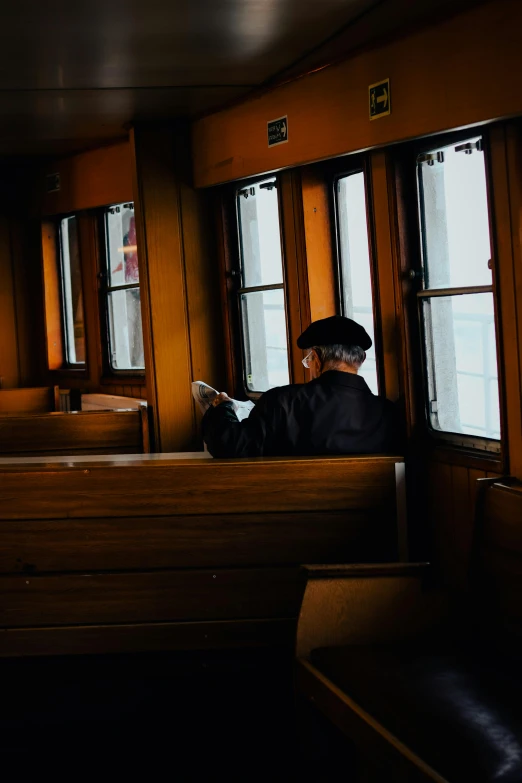 a man in a suit sitting in the front of some benches