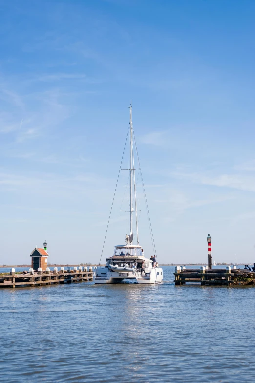 a boat sits moored next to a pier on a sunny day