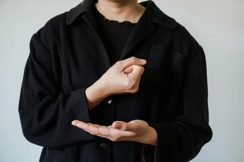 man standing while holding his hands together