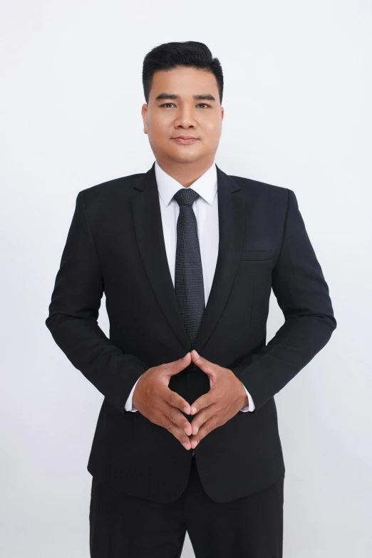 young man in suit and tie posing for po