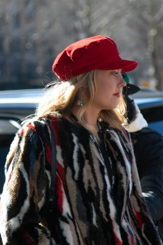 a blonde woman walking with a man behind her